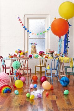 a table with balloons and decorations on it