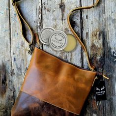 "Handcrafted, Functional and Stunning. This eye catching crossbody is meant for everyday functionality. The beautiful top grain buffalo leather stands out in a crowd and is sure to be a show stopper. This crossbody is just the right size to become your everyday bag that can be used for just about any of your needs hands free.  From day to night this bag is perfect! Gets more vintage with every use, the leather will soften with each use.   Available to buy with a 1 oz. tin of leather conditioner Everyday Crossbody Saddle Bag With Waxed Finish, Everyday Waxed Finish Crossbody Saddle Bag, Everyday Leather Shoulder Bag With Patch, Leather Satchel Shoulder Bag With Patch, Large Crossbody Bag, Large Crossbody Bags, Leather Stand, Buffalo Leather, Leather Conditioner