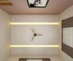 a clock mounted to the side of a wall in a room filled with white walls