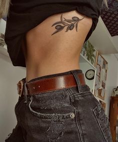 a woman with a tattoo on her lower back