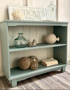 a blue shelf with some sea shells on it