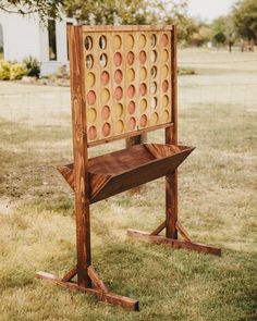 an odd looking chair sitting in the middle of a field with circles on it's back