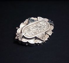 "For sale is a gorgeous antique late Victorian studded silver brooch from the 1880s featuring delicately etched ivy leaf patterns. The brooch is of a great size, and is in very good antique condition. Marks \"STANDARD SILVER\" on the back. It will make a great gift to yourself or someone you care about.   The ivy leaves design at that time represents long lasting love or friendship. So it will especially be the perfect gift if you want to give a friend or your love ones something special and valuable.     Measurements:   Length: 1.875\" (with pin); 1.75\" (without pin) Width: 1.06\" Thickness: 0.5\" (with pin); 0.25\" (without pin)   Materials: 100% Silver   Hallmark: \"STANDARD SILVER\"   Please see details in the photos. If you have any questions feel free to send me a message. Please vi Silver Engraved Heirloom Brooches, Silver Heirloom Engraved Brooches, Victorian Silver Engraved Brooch, Victorian Engraved Silver Brooch, Silver Victorian Engraved Brooch, Victorian Engraved Silver Brooches, Silver Engraved Victorian Brooches, Ladies Gents, Ivy Leaf