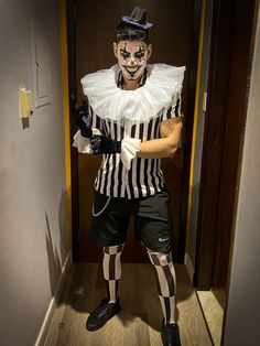 a man dressed as a mime in a hallway