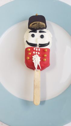 a cake shaped like a nutcracker on a stick