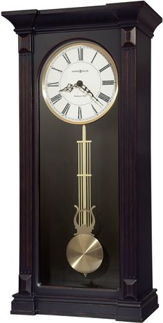 an antique clock with roman numerals and a pendulum on the front, in black wood