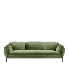 a green velvet couch against a white background