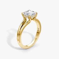 a yellow gold engagement ring with an oval cut diamond in the center and twisted band