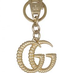 a gold colored metal key chain with a letter g on the front and an o at the bottom