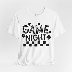 Level up your game night wardrobe with our Game Night T-Shirt, the ultimate attire for board game enthusiasts. Crafted from high-quality, super soft fabric, this unisex tee ensures maximum comfort during those intense gaming sessions. Available in a variety of colors and sizes, it's the perfect fit for any gamer. Featuring a bold "Game Night" design, this shirt is a great conversation starter and an ideal gift for the board game lover in your life. Whether you're hosting a game night or attendin White Graphic Print Sleep T-shirt, Game Lovers, Gaming Shirt, Unique Shirt, Gamer Gifts, Night Shirt, Game Night, Jersey Shorts, Board Games