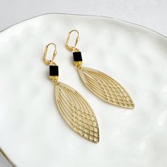 This season, glow for gold in this statement pair with trendy geometric shapes. GEMSTONE: Onyx MATERIAL: Signature brushed gold plating on brass CLOSURE: Gold plated leverback LENGTH: 2.75" long Elegant Gold Geometric Earrings, Elegant Geometric Gold Earrings, Gold Geometric Earrings For Formal Occasions, Gold Geometric Earrings For Party, Geometric Gold Earrings For Party, Gold Geometric Jewelry For Party, Trendy Gold Geometric Earrings, Chic Gold Geometric Jewelry, Chic Geometric Gold Jewelry