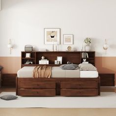 a bedroom with a bed, bookcases and drawers on the floor in front of it