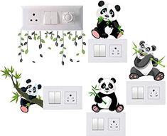 the pandas are playing with each other on the light switch plates, and one is eating bamboo