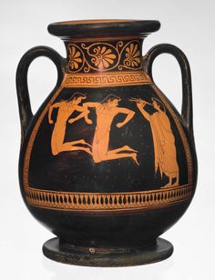 an old black and orange vase with two men on it's sides, possibly from the ancient greek period