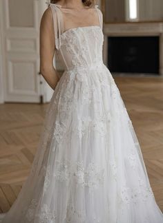 a woman in a white wedding dress posing for the camera