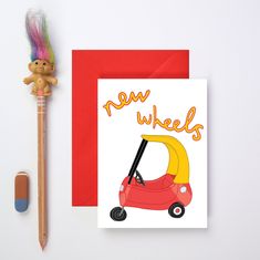 a card with an image of a toy car on it and a pencil next to it