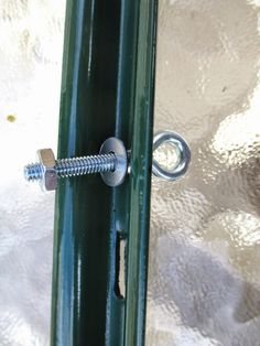 the screw is attached to the green door handle