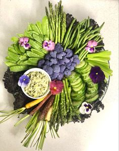 an arrangement of vegetables and dips on a platter