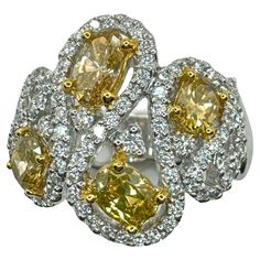 three yellow and white diamond rings on top of each other, surrounded by diamonds in the middle