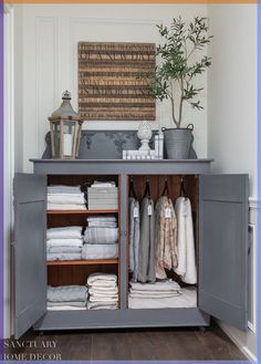 an open cabinet with towels and other items on the top shelf in front of it