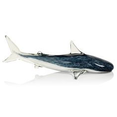 a silver and blue whale figurine on a white background