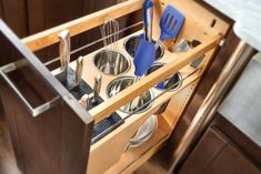 an open drawer with utensils in it