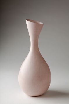 a white vase sitting on top of a table