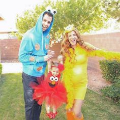 a man, woman and child dressed up in costumes