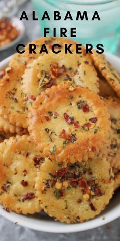 a white bowl filled with crackers covered in cheese and seasoning on top of a table