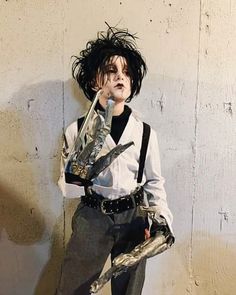 a man dressed up as michael jackson holding a pair of scissors in his right hand