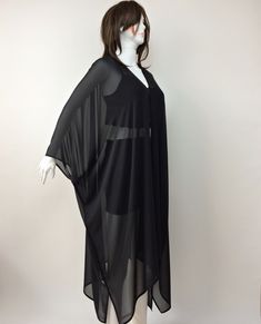 "This wonderful loose kimono is made of black silk georgette chiffon fabric. You can use this sheer plus-size cardigan with jeans or shorts. Also, it can wear as a beach cover-up on your swimsuit. This is a see-through sheer long jacket. Use it as casual wear. You will look fabulous when you wear this lightweight long caftan. This summer jacket would be a perfect gift for you or your loved ones. The boho solid kimono top is excellent, fun, and chic. It is a great gift for travel lovers. It is so Elegant Long Flowy Cover-up, Black Long Kimono For Beach Cover-up, Elegant Long Sleeve Kimono For Beach Cover-up, Black Summer Party Kimono, Flowy Long Sleeve Chiffon Kaftan, Flowy Chiffon Long Sleeve Kaftan, Black Long Party Cover-up, Black Open Front Kimono For Beach Cover-up, Black Long Sleeve Kimono For Beach Cover-up