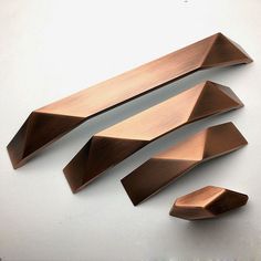 three pieces of metal are shown on a white surface with the words brushed copper written below them