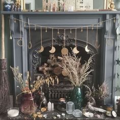 a fire place with various items on it and decorations hanging from the fireplace mantel