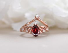 It protects the wearer from negativity and evil thoughts. It induces passion, fire, energy, stability, and is believed to bring good luck in love and relationships. Garnet is a stone meant to bring success in life and helps to achieve the goals set in life by its possessor. Gemstone: Red Garnet Shape/Size: Pear 8X6 MM  Finish Type: Choose From Above Options Metal Type: 925 Sterling Silver/ Solid 14K Gold Also Available Red Garnet Bridal Crown Ring Set, 14K Rose Gold Curved Band Ring, Promise Engagement Ring, Matching Band, Stackable Ring, Gift For Your Queen Engagement RingsGift For HerAnniversary GiftSalt and Pepper RingBeautiful Crown RingStone For WeddingUnique Bridal RingsGift For Special OneRed Garnet RingGarnet crown RingCurved band RingRose Yellow GoldWedding Jewelry Fire Energy, Evil Thoughts, Ring Matching, Crown Ring, Bridal Crown, Stackable Ring, Ring Promise, Matching Band, Red Garnet