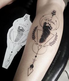 a person with a tattoo on their arm that has a bear's paw and arrow