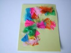 colorful feathers are placed on top of a piece of paper