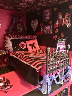 a bedroom decorated in pink and black with pictures on the walls, bedding and accessories