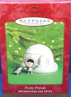 a christmas ornament in a box with a little boy on it