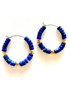 Natural blue lapis lazuli gemstone with 24k gold vermeil accents on one inch 14k gold fill hoops. Also available in .925 sterling silver.  Slightly matte blue lapis lazuli heishi beads are 4 x 2mm accented with 24k gold vermeil spacers. Hoops are 1 inch diameter. Blue Beaded Small Hoop Jewelry, Handmade Royal Blue Round Beads Jewelry, Blue Brass Round Jewelry, Blue Round Brass Jewelry, Blue Hoop Brass Jewelry, Blue Brass Hoop Jewelry, Blue Round Beads Spiritual Earrings, Blue Round Earrings With Gemstone Beads, Blue Bohemian Hoop Earrings With Natural Stones