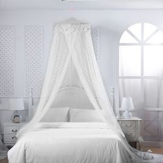 a white bed with a canopy over it