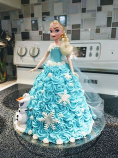 a frozen princess cake on top of a stove