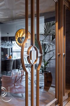 an open glass door leading into a dining room