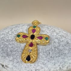 Byzantine style Greek Cross made of 18 carat solid yellow gold with genuine precious gemstones The Cross is decorated with different shapes Rubys,Sapphires,Emeralds and a Diamond 0.10 ct. Total weight of te colored stones is 3.20 ct. The specific Croos has been manufactured in one of the oldest jewelry workshops in Athens which is famous for production of byzantine jewelry It is a handmade Cross with spirals and grains Made in Greece inspaired by Byzantine art jewelry A beautiful piece of jewelr Luxury Gold Multi-stone Gemstones, Gold Byzantine Jewelry With Multi-stone, Gold Byzantine Multi-stone Jewelry, Byzantine Multi-stone Jewelry As Gift, Luxury Gold-colored Gemstones, Luxury Gold Pendant Gemstones, Luxury Handmade Gold Gemstones, Gold Byzantine Jeweled Jewelry, Byzantine Jeweled Gold Jewelry