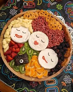 a wooden bowl filled with different types of snacks