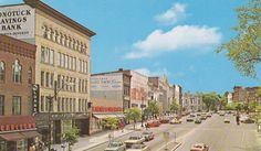 an image of a street scene with cars on the road and buildings in the background