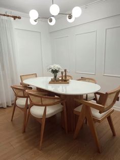 a white table with four chairs around it