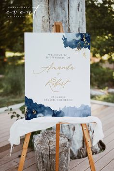 an easel with a sign on it that says welcome to the wedding of amanda and robert