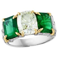 Vintage approximately 4.5 Ct Emerald Cut TWO Colombian Emerald & 2 Ct Solitaire Diamond Three stone Ring. Estate piece Natural very fine Colombian Emerald. There are two pieces of very very fine Colombian emeralds each about 2.25 ct. Center is approximately 2 ct of Cushion shape solitaire diamond. Two Emerald cut Diamonds on either side of the diamond. 18 K White gold 6.2 Gm. Emerald: approximately 4.5 Ct. Origin: Colombia. Color: Deep Green, Transparent extreme Fine Color Quality. One of our finest Colombian Emerald ring. Cut: Emerald Cut. One of our top Emerald ring from the premium collection. Color is so beautiful. It's important to note that all natural emeralds have tiny black dots called inclusions, which can be seen in some of the pictures. As with all natural emeralds, inclusions Emerald Cut Green Diamond Ring With Multi-stone, Luxury Green Emerald-cut Diamond Ring, Columbian Emerald Ring, Colombian Emerald Earrings, Colombian Emerald Ring, Emerald Wedding Rings, Emerald Cut Engagement, Emerald Diamond Ring, Platinum Diamond Rings