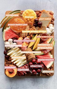 a wooden tray filled with different types of fruits and vegetables on top of each other