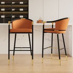 two chairs sitting next to each other in front of a counter top with bottles on it